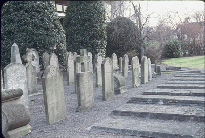 black and white photo of a row of graves