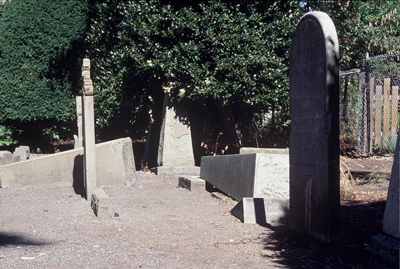 colour photo of overturned monuments and headstones